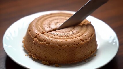 Detailed CloseUp of Delicious Kue Mangkok Sliced on White Plate A Culinary Delight on Brown Wooden Table Perfect for Bakery Promos and Sweet Treat Ads Showcasing Culinary Skills and Homemade Goodness