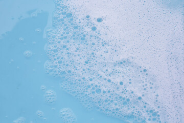 Blue water with white foam bubbles