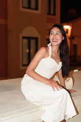 Young Asian woman tourist with long black hair in European style town at night