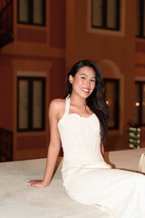 Young Asian woman tourist with long black hair in European style town at night