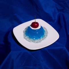 blue jelly with white plate on blue background