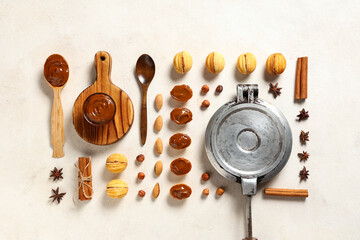 Arrangement with tasty walnut shaped cookies, boiled condensed milk, ingredients and baking form on...