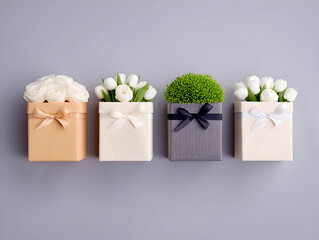Gift boxes decorated with white roses, tulips, green foliage, neatly arranged on gray surface, ribbons enhancing elegant festive styling