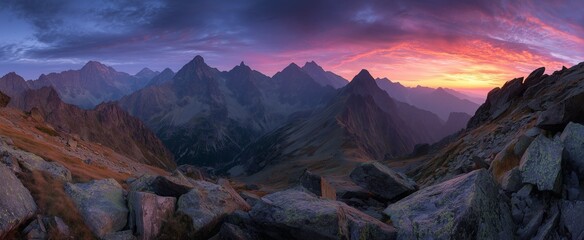 Naklejka premium Panoramic wide-angle photo of the Tatra Mountains at sunrise,featuring rugged peaks, rocky terrain, and vibrant red-orange hues under a clear summer sky during golden hour