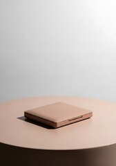 Elegant square compact resting gracefully on a smooth round table surface still life