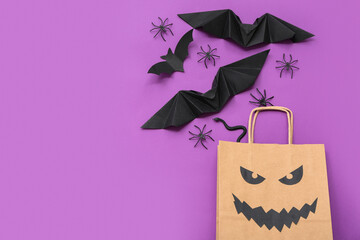 Composition with shopping bag, paper bats and spiders for Halloween on color background