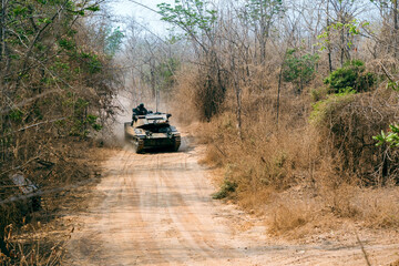 Armored on Patrol, A armored vehicles carrying armed soldiers advances along a dirt path during a...