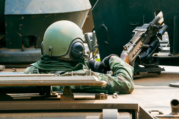 Soldier Using Communication Device, A soldier in full combat gear communicates via radio while...