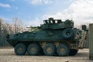 Armored on Patrol, A armored vehicles carrying armed soldiers advances along a dirt path during a...
