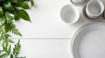 Fresh tabletop with greenery and dishes, soft indoor light, white wood surface