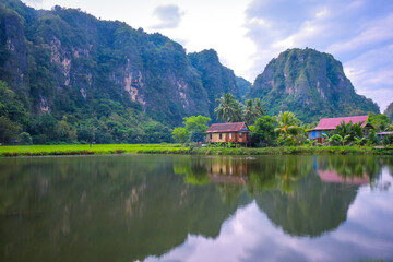 Fototapeta premium Beautiful limestones and water reflections in Rammang Rammang park near Makassar, South Sulawesi, Indonesia