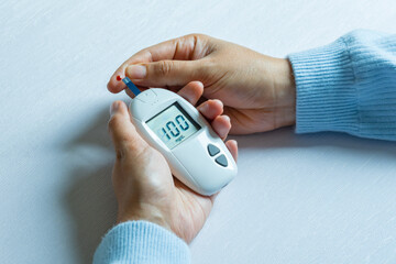 hand of people check diabetes and high blood glucose monitor with digital pressure gauge....
