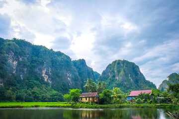 Fototapeta premium Beautiful limestones and water reflections in Rammang Rammang park near Makassar, South Sulawesi, Indonesia