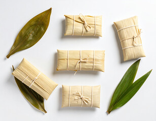 Tamale covered in rich mole sauce and sesame seeds, sliced open to reveal filling on a banana leaf.
