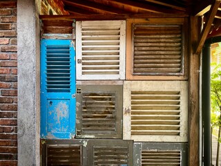 Colorful old wooden windows arranged to decorate the building facade