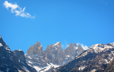 View in Italy with the peaks of the Dolomites in the distance with blue sky