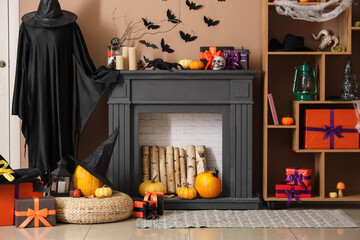 Interior of festive living room with fireplace, Halloween decorations and gift boxes