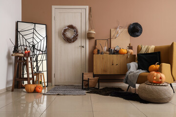 Interior of hall decorated for Halloween with door, drawers and armchair