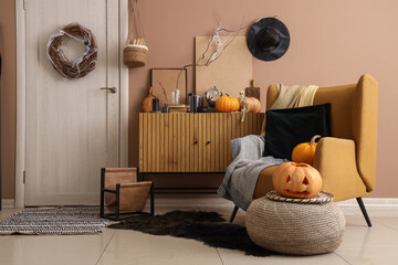 Interior of hall decorated for Halloween with door, drawers and armchair
