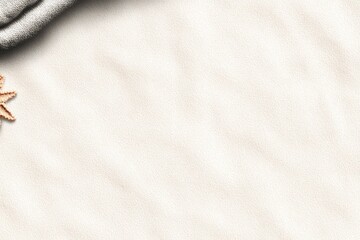 Naklejka premium Beige sand surface with a light gray cloth draped over a corner and a light brown starfish