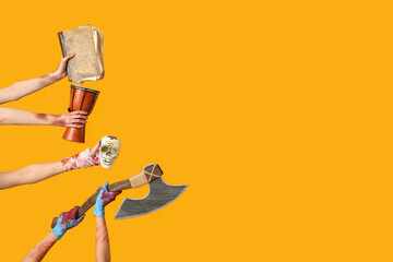Hands of zombies with old book, drum, human skull and axe on yellow background. Halloween...