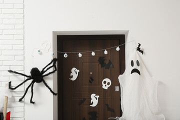 Door with Halloween decor in hallway