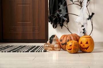 Halloween pumpkins near door in hallway