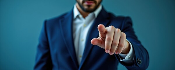 Businessman Pointing Forward in Formal Suit Against Blue Background