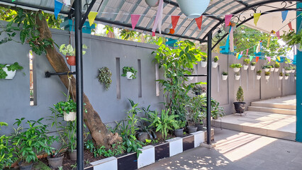 Beautifully decorated and well-maintained outdoor space at a pathway or corridor in a school or residential area, adorned with plants and festive decorations. Vertical garden..