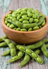 Fresh edamame beans in a wooden bowl with pods on a rustic table