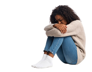 A sad and lonely young African-American woman curled up on the floor with her head down on a transparent background.