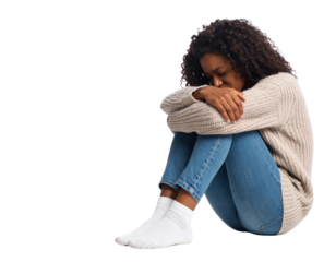 A sad and lonely young African-American woman curled up on the floor with her head down on a transparent background.