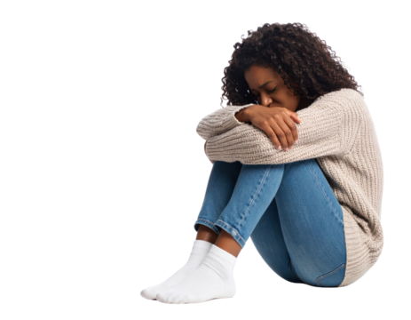 A sad and lonely young African-American woman curled up on the floor with her head down on a transparent background.