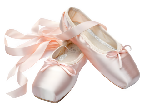 Pair of pink satin ballet pointe shoes with ribbons on a black background