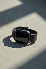 A minimalist product photo of smartwatch on concrete background, side lighting highlighting sleek design