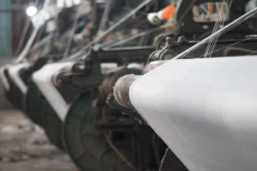 Machines operate in a textile factory during work hours