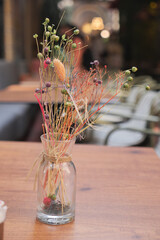 Beautiful dried flower arrangement on wooden table