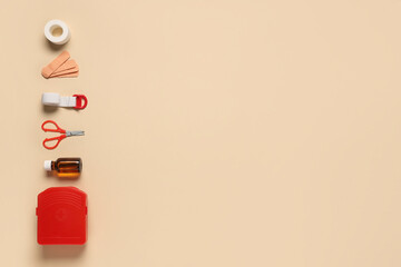 Composition with first aid kit and medical supplies on beige background