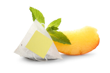 Piece of tasty peach, mint leaves with tea bag isolated on white background, closeup