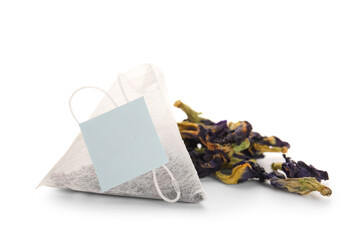 Dried butterfly pea flowers with tea bag isolated on white background, closeup