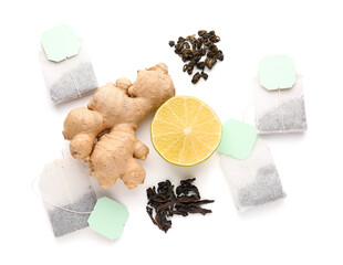 Composition with dry tea leaves, ginger root, lemon and tea bags isolated on white background,...