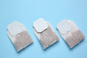 Tea bags on blue background, closeup