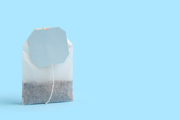 Tea bag on blue background, closeup
