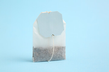 Tea bag on blue background, closeup