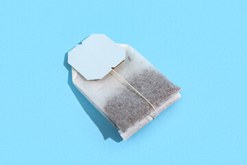 Tea bag on blue background, closeup