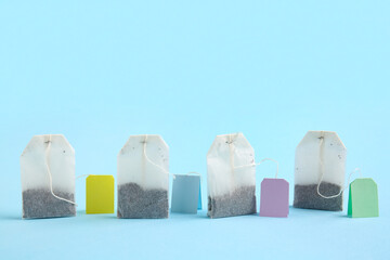Different tea bags on blue background, closeup