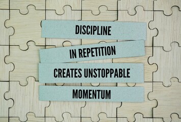 Inspirational and motivational words or quotes for success: discipline in repetition creates unstoppable momentum