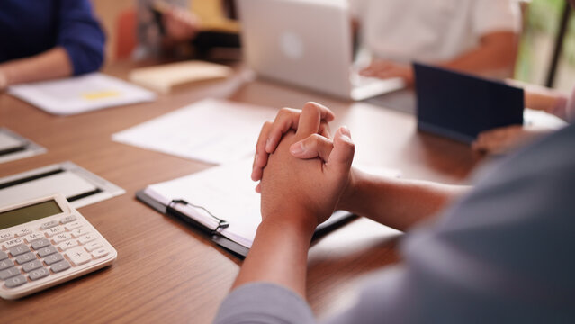 Asian adult business professionals discussing corporate strategy financial planning at office meeting room focused collaboration decision making