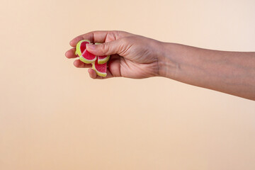 Fruit jelly mixed with sugar and hand on cream background
