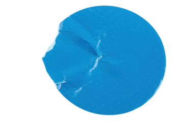 A bright blue circular sticker with a torn edge and visible creases is isolated on a plain transparent background